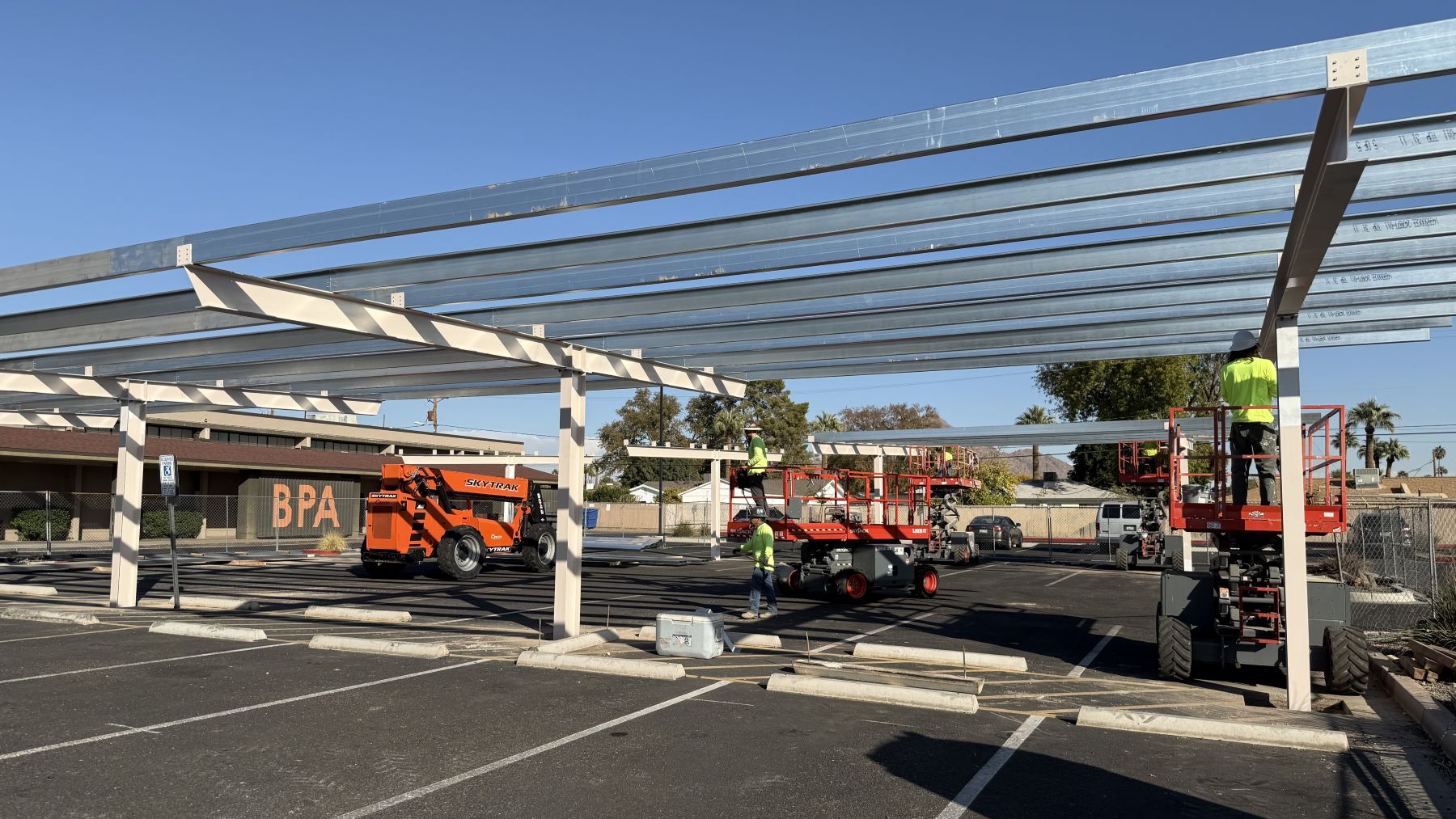 Creighton District staff building a solar array above a parking lot