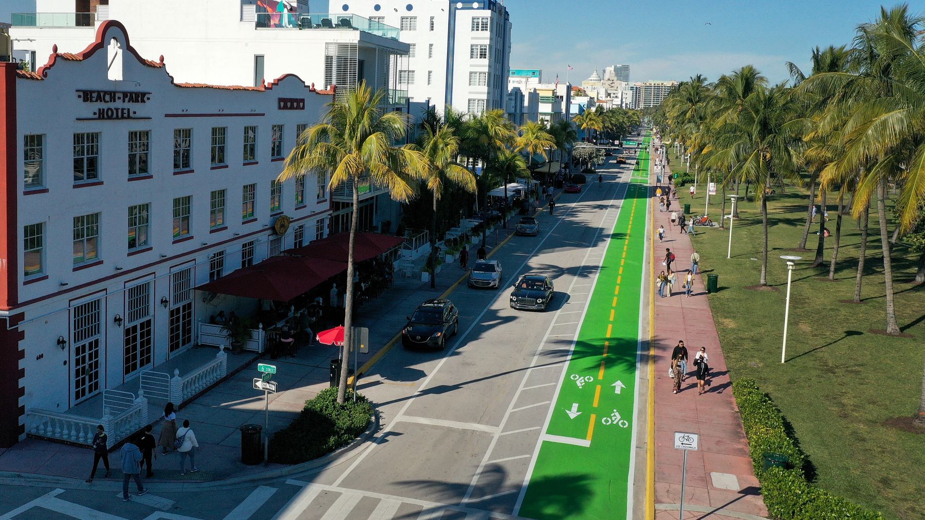 Aerial view of a street with a car lane, bike lane, and people walking